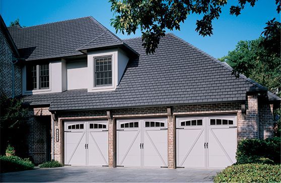 Large home with a three-car garage with white garage doors.