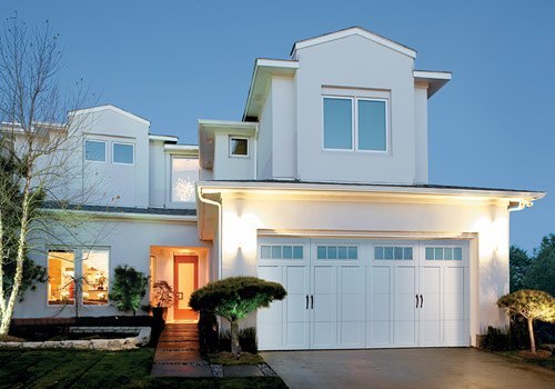 Modern carriage garage door on a while home