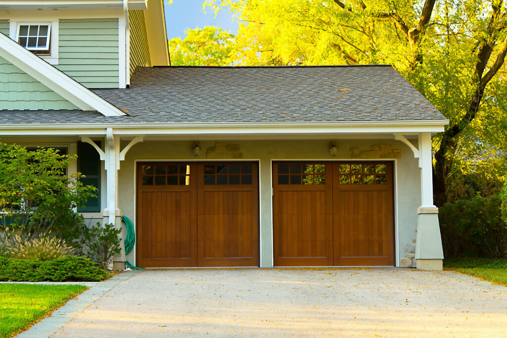 Two-car garage with wooden garage doors.