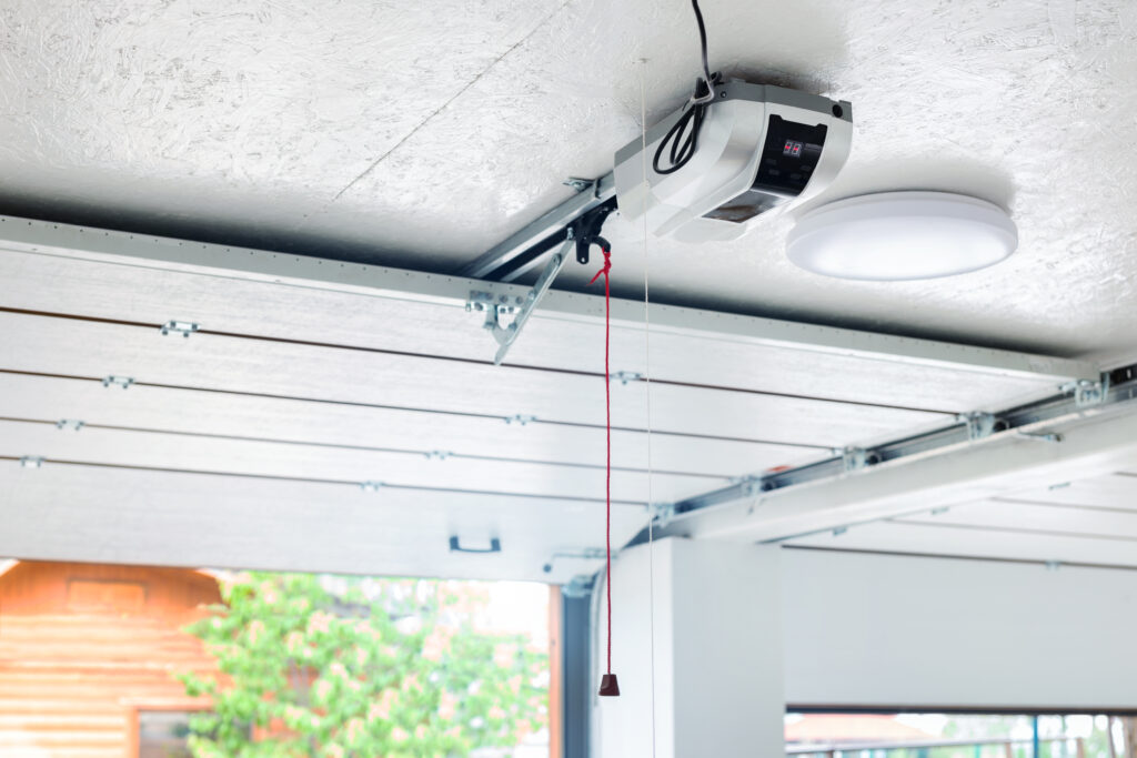 Open garage door with garage door opener installed on the ceiling